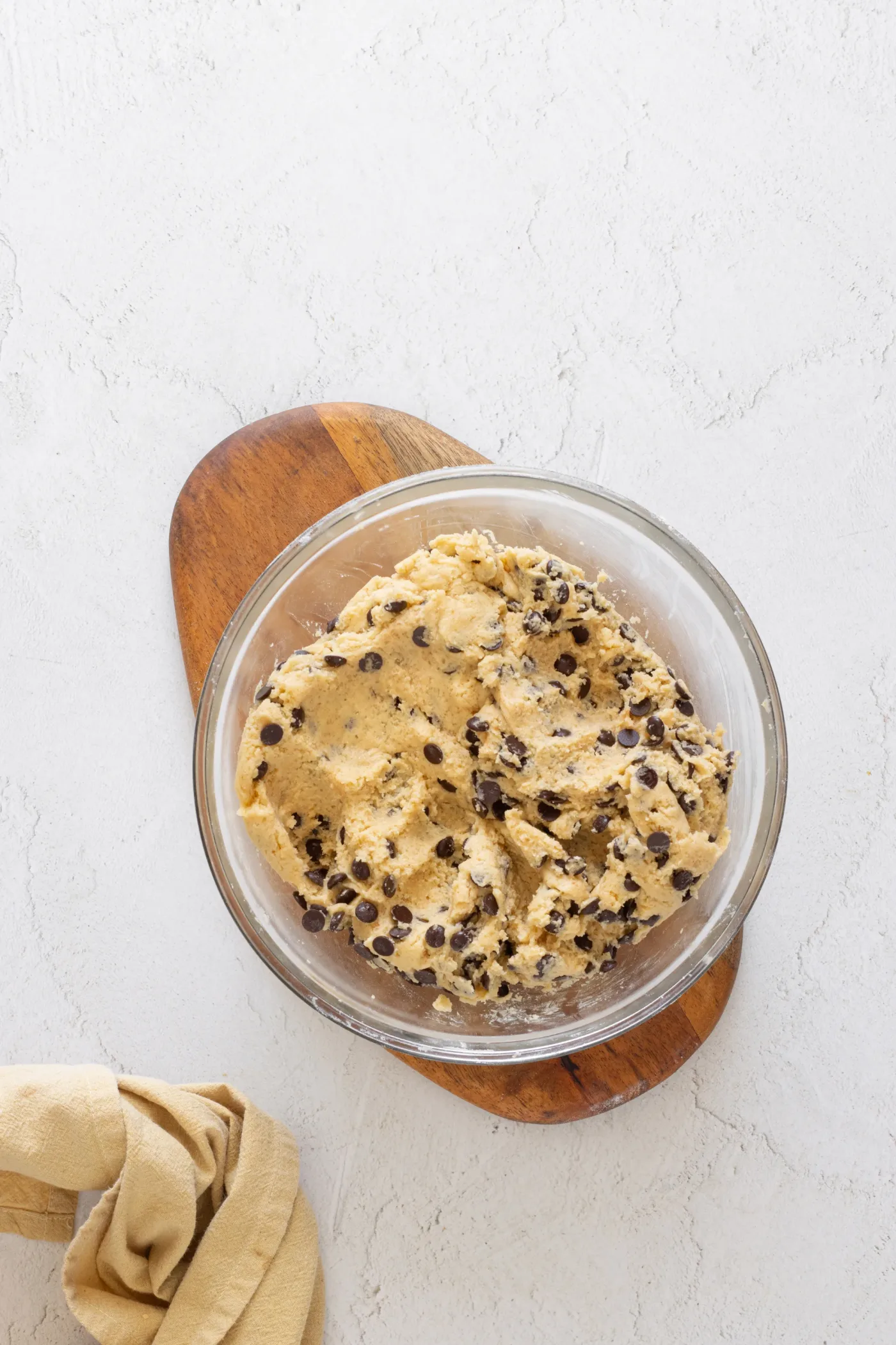 Finished brown butter chocolate chip cookie dough in a glass bowl